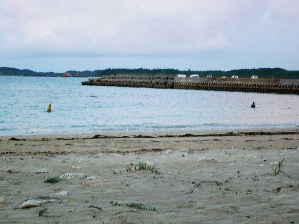 宜野座村のビーチで海に浸かる人の影。